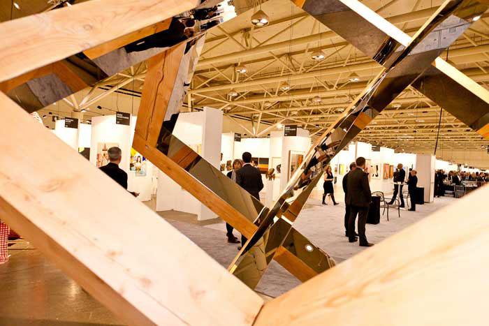 A view of Art Toronto 2011 through Ross Bell's <em>Strip Cube</em> at the Georgia Scherman Projects booth / photo courtesy of Art Toronto and Arash Moallemi