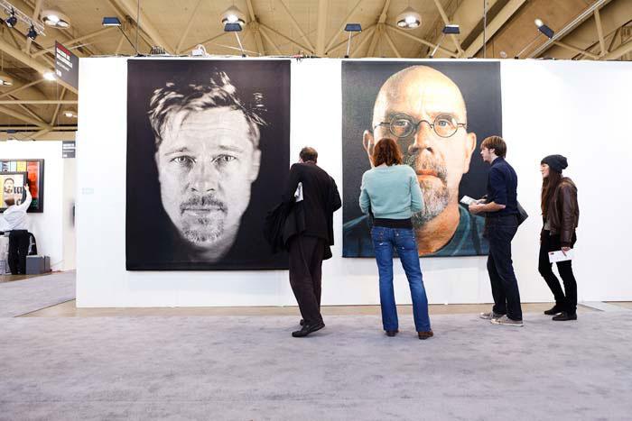 Visitors admiring work by Chuck Close at Galerie de Bellefeuille’s booth during Art Toronto 2011 / photo courtesy of Art Toronto and Arash Moallemi