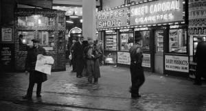 James Crookall The tram news stand and coffee shop illuminated at night in the B.C. Electric building at 425 Carrall Street  1937 Courtesy City of Vancouver Archives