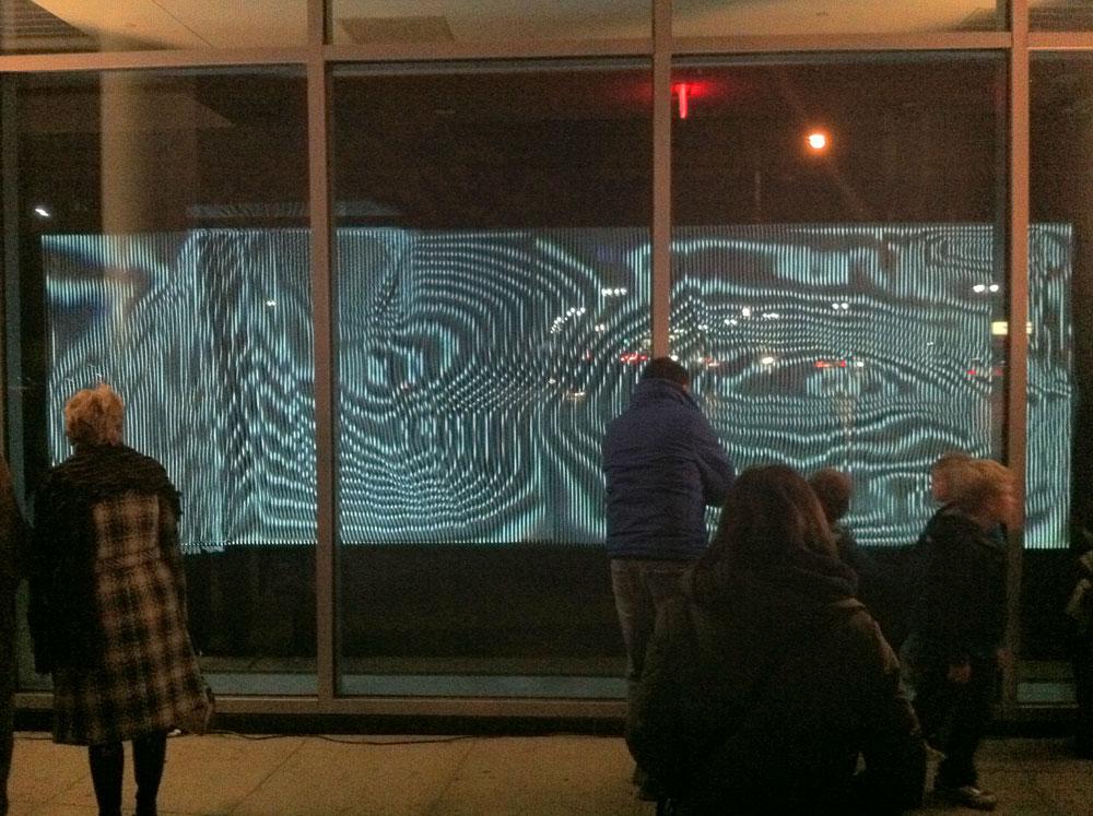 Annica Cuppetelli and Cristobal Mendoza’s interactive installation <em>Notional Field</em> in the windows of the Wayne State University Welcome Center / photo David Balzer 