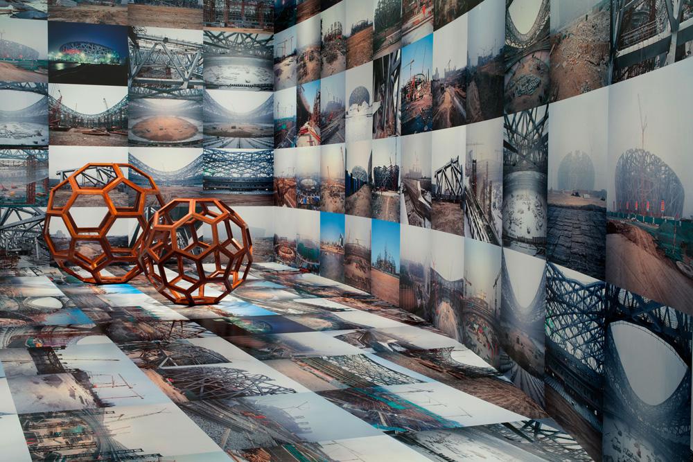 Ai Weiwei (background) <em>Beijing’s 2008 Olympic Stadium</em> 2005–8 (foreground) <em>Divina Proportione</em> 2006 and <em>F-Size</em> 2011 Installation view Courtesy Hirshhorn Museum, Washington / photo Cathy Carver