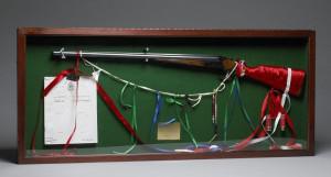 Lawrence Paul Yuxweluptun An Indian Act Shooting the Indian Act, Healey Estate Northumberland September 14th, 1997 1997 Rifle, ribbon, used bullet shells and paper in display frame 55 cm x 1.26 m overall Courtesy National Gallery of Canada / photo &copy; NGC